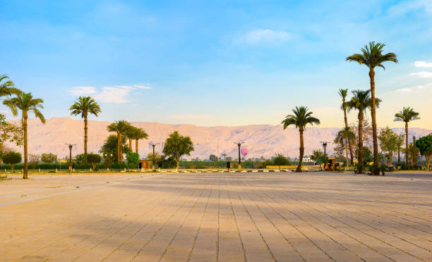 Square near Karnak Temple in Luxor with the view on palm trees and mountains at sunrise
