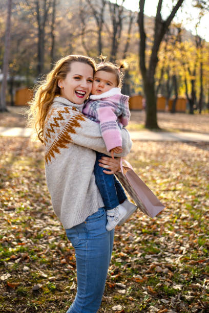 istock Mother with daughter in autumn park 1189794654