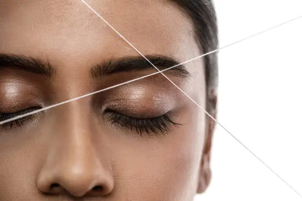 Photo of Eyebrow threading - epilation procedure for brow shape correction