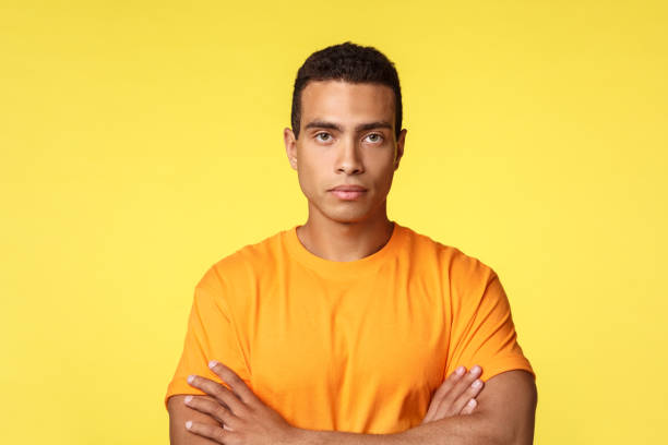istock Serious-looking man getting angry, look strict and determined, cross arms chest having important conversation, motivated win in competition, standing over yellow background confident 1189796030