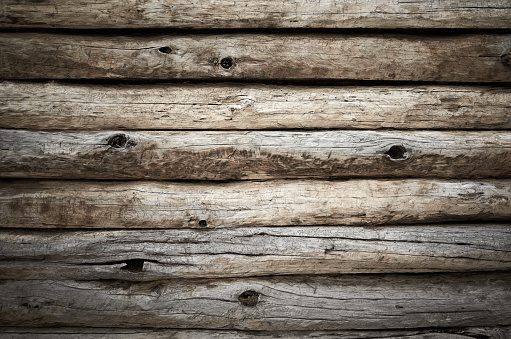 Beige old grunge wall from wooden logs knots