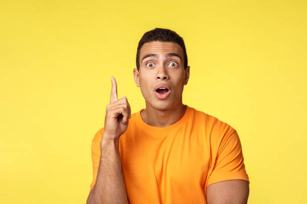 istock Got idea. Man say eureka as gasping and give advice, lighten with amazing idea, raise one finger in got-it gesture, stare camera talking to friend, standing yellow background excited 1189796598