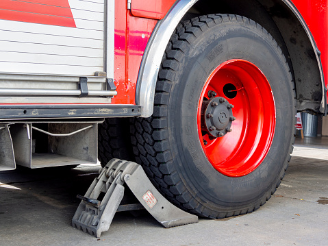 Wheel chock to prevent fire truck from rolling