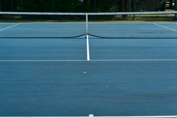 istock Tennis courts with blue surface and mesh fences 1189799320