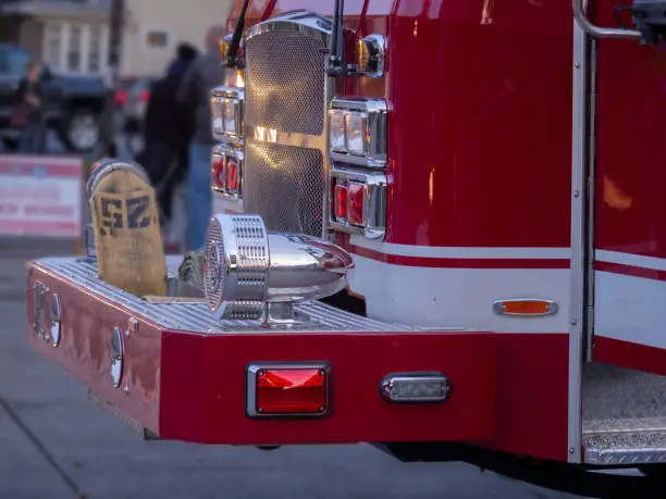 Fire truck at dusk with a crowd of onlookers in the background