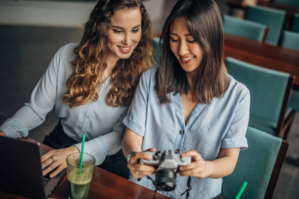 istock Two cheerful women in a cafe 1189799623
