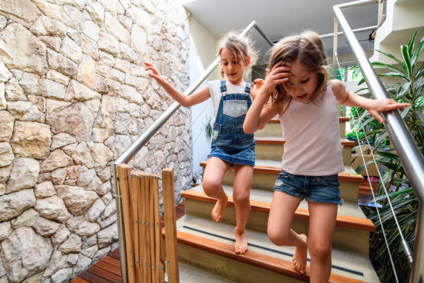 istock Hurrying Young Sisters Carefully Descending Staircase 1189800625