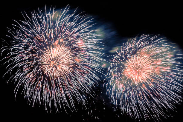 istock A beautiful Fireworks light up the sky with dazzling display on dark background. 1189802980