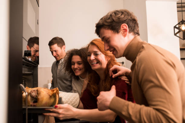 istock Family in the kitchen preparing Thanksgiving dinner 1189803415
