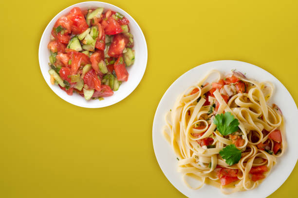 istock spaghetti on a white plate. spaghetti tomatoes, onions, cabbage on a colored background. healthy food 1189803470
