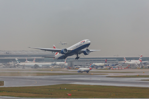 British Airways Boeing 777 GSTBH Taking off from LHR International Airport in bad weather