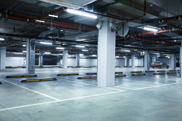 istock Horizontal image of a motion blurred car on empty underground parking lot 1189806618