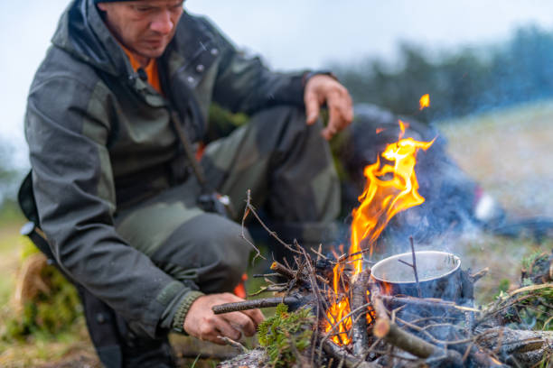 istock Man cooking on a campfire in the wilderness 1189807475