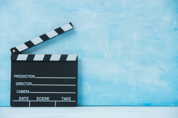 istock Movie clapper on blue background, cinema concept