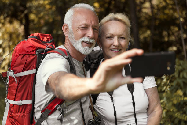 istock Senior couple taking a selfie on a hiking track 1189811593