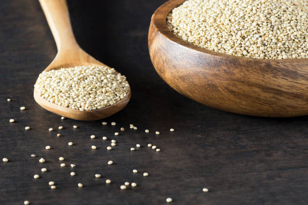 istock White quinoa seeds in wooden spoon and bowl on rustic background ( Chenopodium quinoa ) 1189813238
