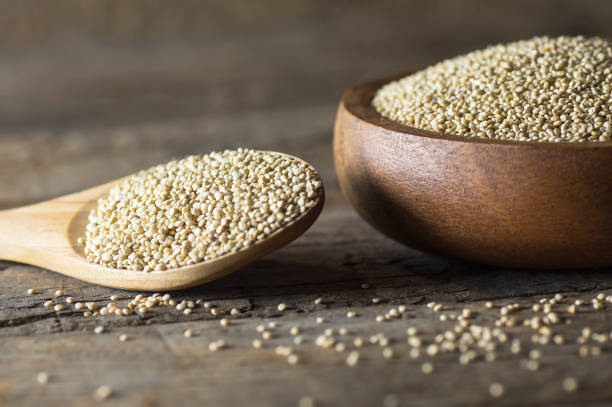 istock White quinoa seeds in wooden spoon and bowl on rustic background ( Chenopodium quinoa ) 1189813801