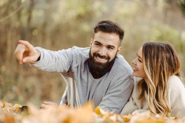 istock Beautiful young couple lying in nature 1189813967