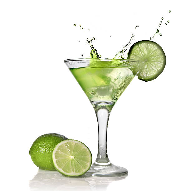 istock Green alchohol cocktail with lime and splash on white 118981462