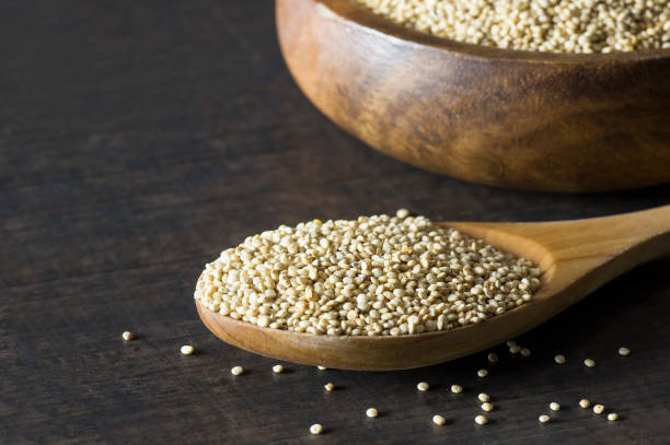 istock White quinoa seeds in wooden spoon and bowl on rustic background ( Chenopodium quinoa ) 1189815898