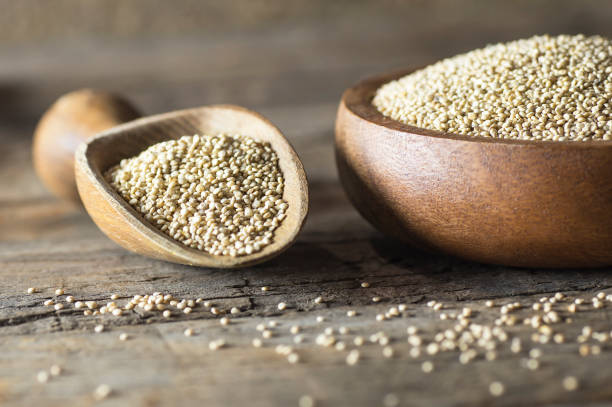 istock White quinoa seeds in wooden spoon and bowl on rustic background ( Chenopodium quinoa ) 1189816023