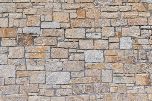 Ancient red stone square shaped wall flat background closeup