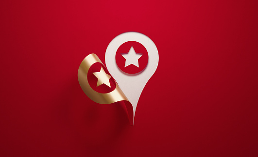 A golden map pointer with star shape folding on red background. Horizontal composition with  copy space.