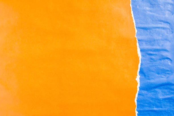 istock Blue and orange crumpled torn gloss paper posters texture background. Can be used for text. 1189820287