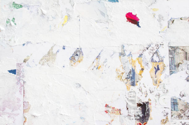 istock Closeup dirty billboard with old torn paper ads texture background. 1189820323