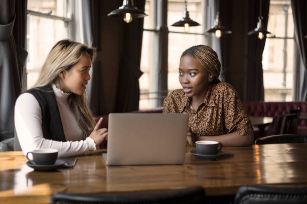 istock Young women working on laptop in cafe 1189822450
