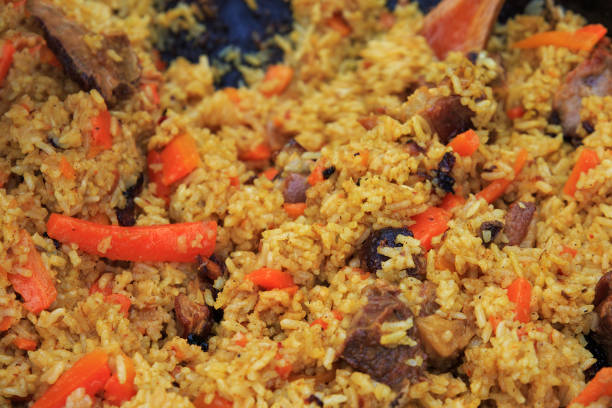 istock Traditional pilaf with lamb preparated on the fire. 1189823702