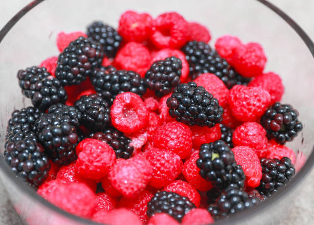 istock mix of different delicious berries closeup. 1189824428