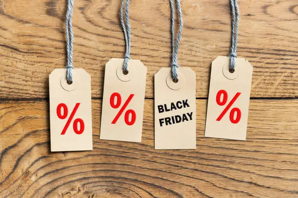 Hangtags with text "Black Friday" on wooden background