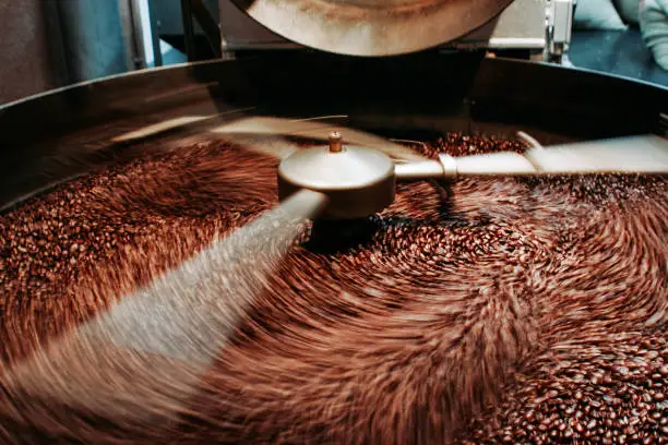 Photo of Coffee roaster machine is preparing fresh coffee beans - stock photo