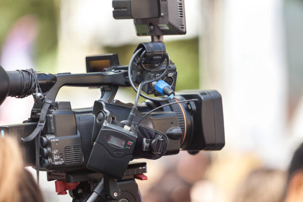 istock Man journalist with a modern large black video camera 1189828581