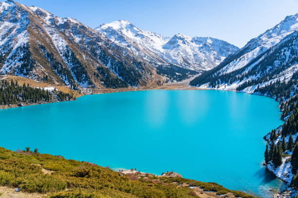 istock Lake with turquoise water surrounded by a mountain massif 1189828596
