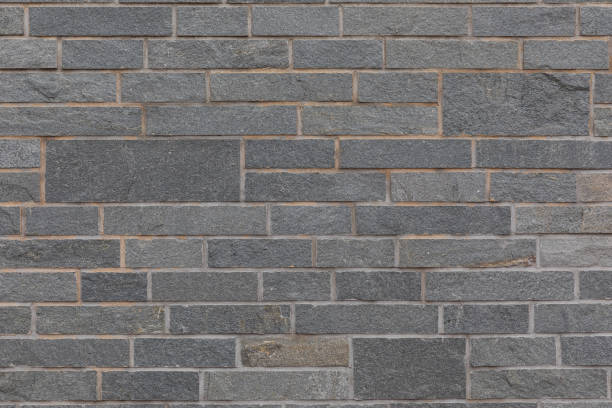 istock Grungy light and dark gray brick tiled wall for background 1189828913