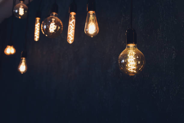 istock light bulb Edison filament retro vintage decor on brick wall background. Lighting decoration. 1189829226