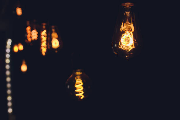 istock light bulb Edison filament retro vintage decor on brick wall background. Lighting decoration. 1189829234