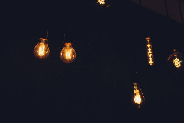 istock light bulb Edison filament retro vintage decor on brick wall background. Lighting decoration. 1189829238