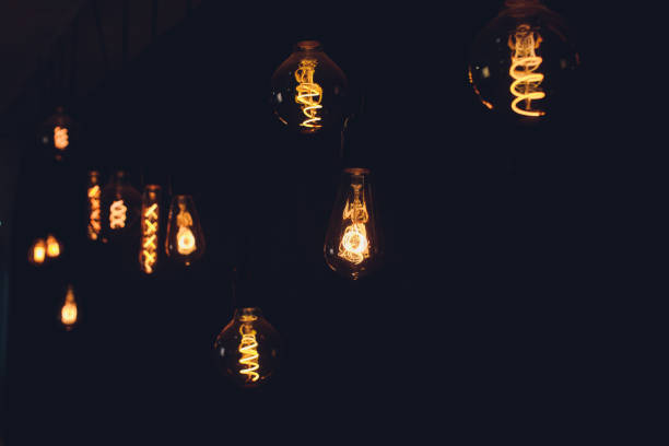 istock light bulb Edison filament retro vintage decor on brick wall background. Lighting decoration. 1189829243