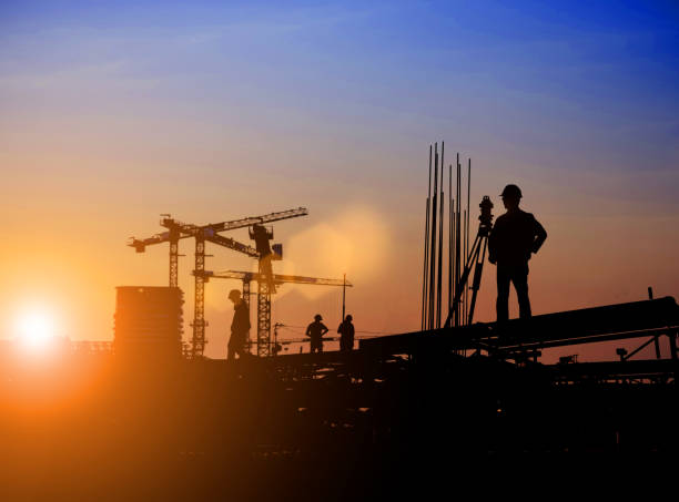 istock Silhouette of Survey Engineer and construction team working at site over blurred  industry background with Light fair Film Grain effect.Create from multiple reference images together 1189829549