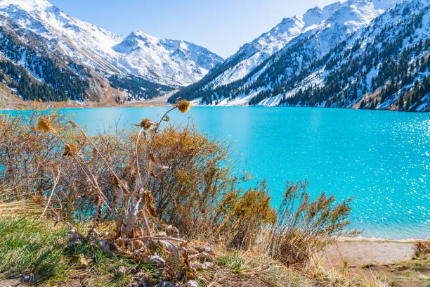 istock Lake with turquoise water surrounded by a mountain massif 1189830974