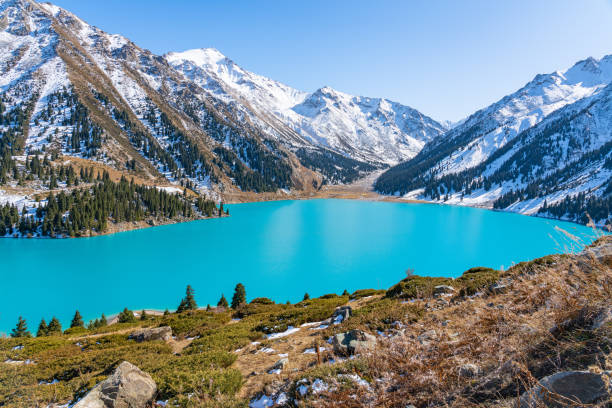 istock Lake with turquoise water surrounded by a mountain massif 1189831148