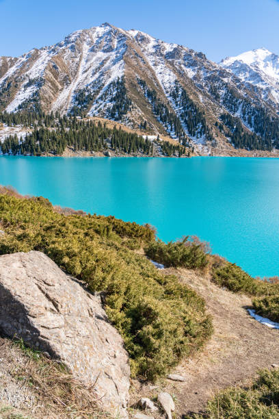 istock Lake with turquoise water surrounded by a mountain massif 1189831842