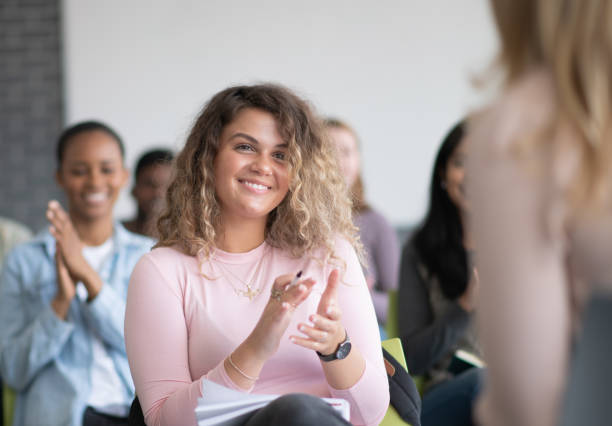istock University Students Sitting in a Lecture Clapping stock photo 1189837613
