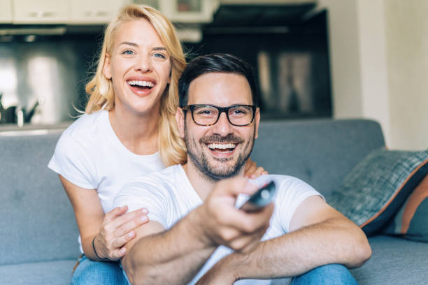 istock Happy couple watching tv 1189838300