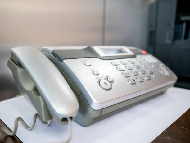 istock Telephone and fax machine on table in office 1189839424