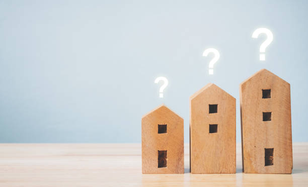 istock Wooden home shape with question mark on wood table and copyspace for your text. Ideas house concept 1189839431