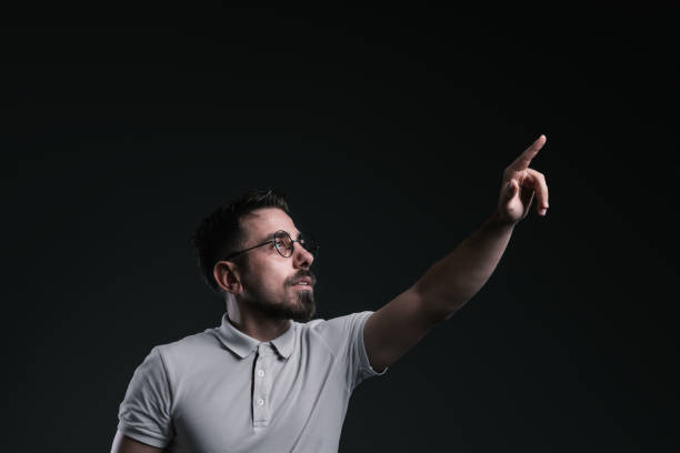 Young man looking pointing and touching futuristic concept stock photo